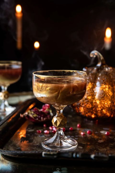 poisoned apple cocktail in a glass with edible gold glitter