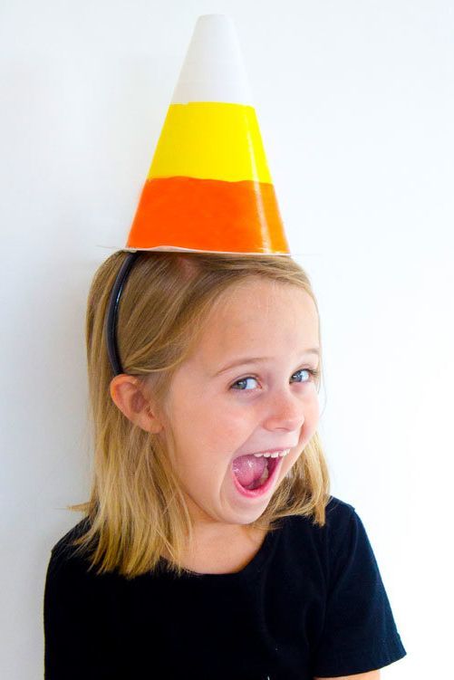 small child wearing diy candy corn party hat and black shirt