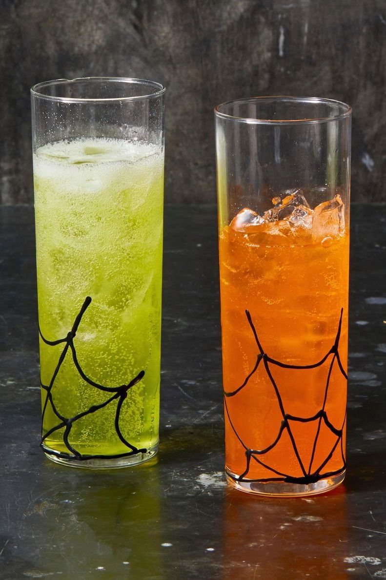 halloween crafts, two glasses with colorful drinks inside and spiderweb patterns