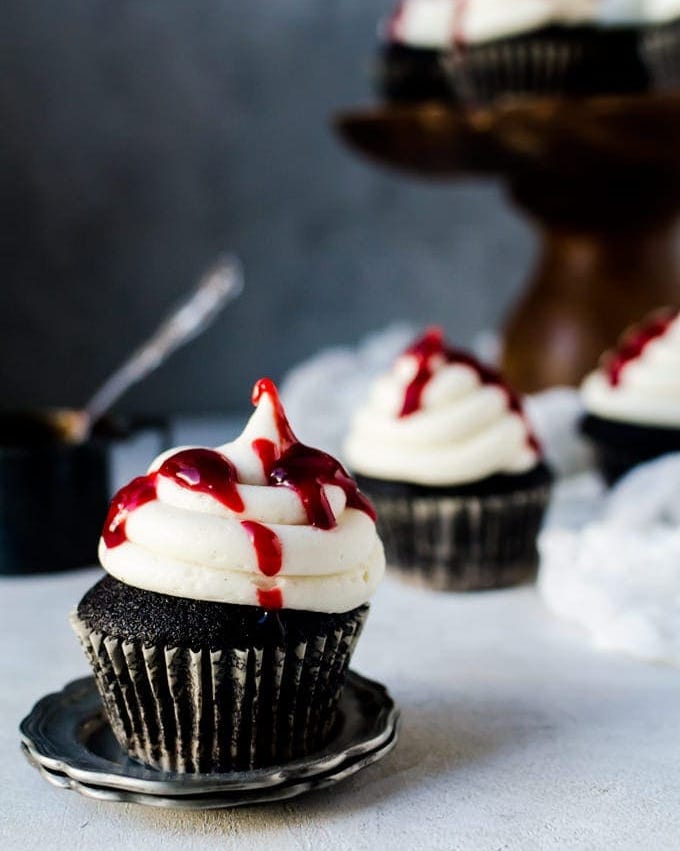 black velvet cupcakes with white frosting and raspberry jam