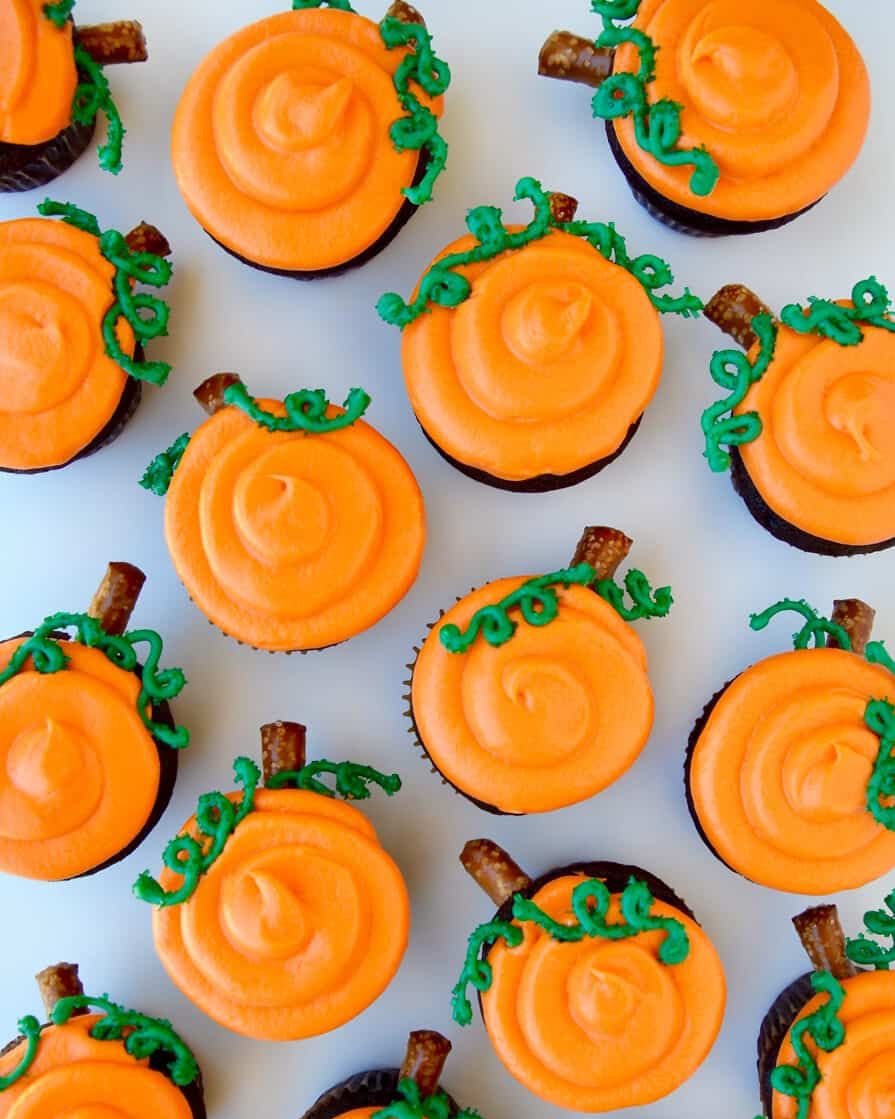 chocolate pumpkin cupcakes with green stems