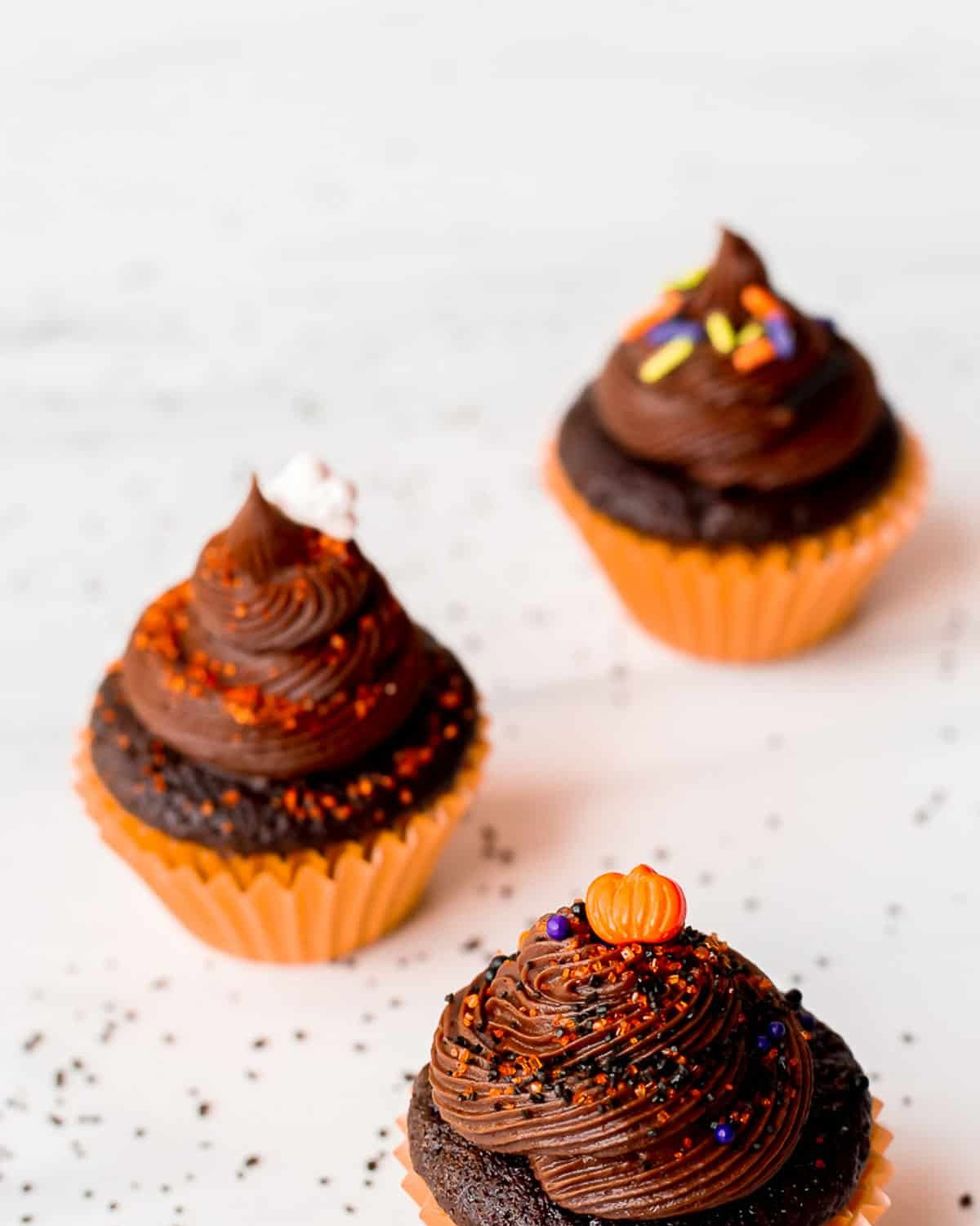 mini chocolate halloween cupcakes with orange pumpkin sprinkles and orange liners