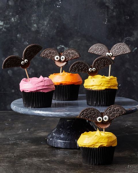 chocolate cookie bat cupcakes with red, orange and pink frosting