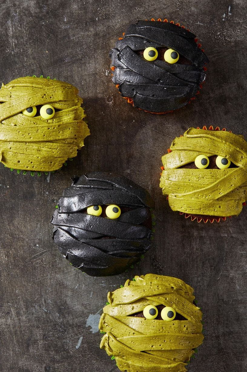 green and black mummy cupcakes with candy eyes