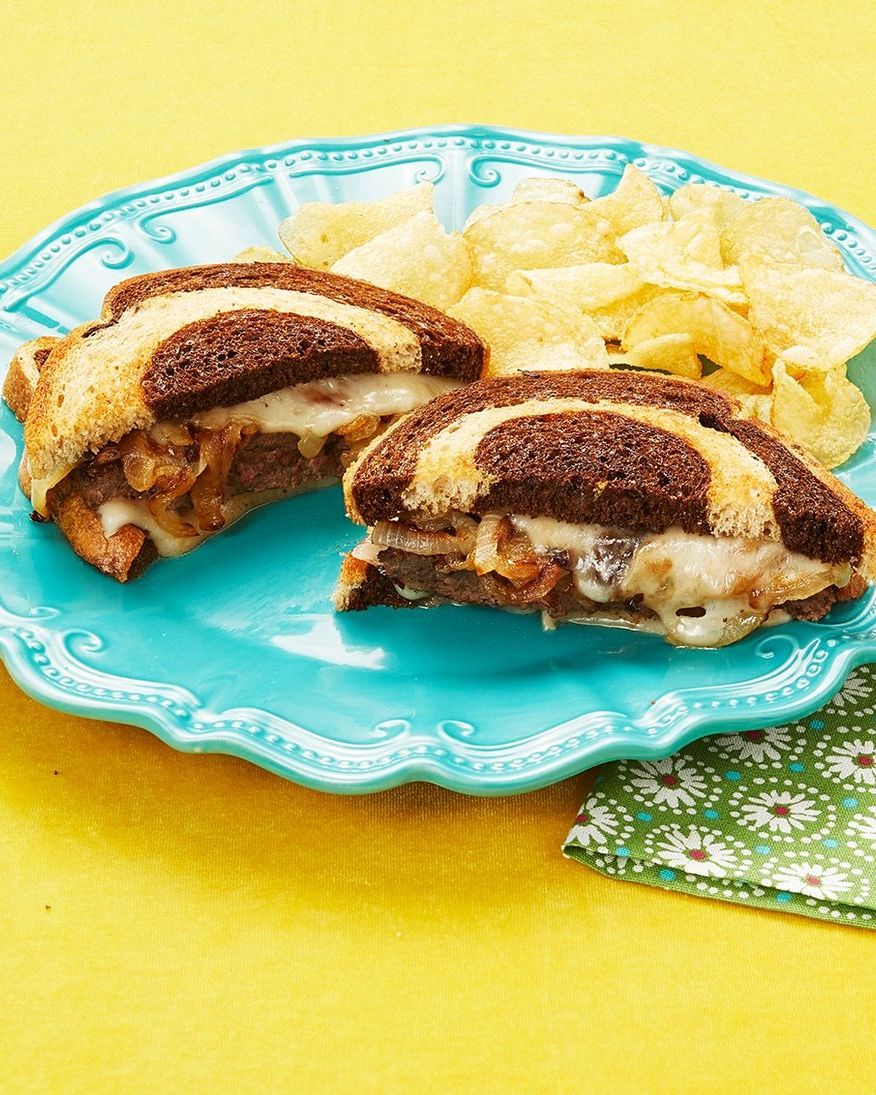 patty melt on blue plate and yellow background