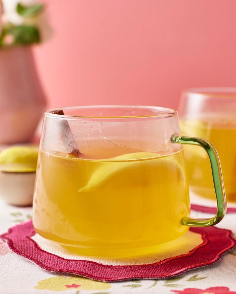 hot toddy in glass mug with lemon and cinnamon