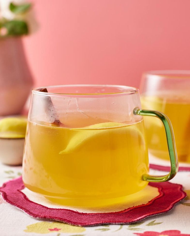 hot toddy in glass mug with lemon and cinnamon