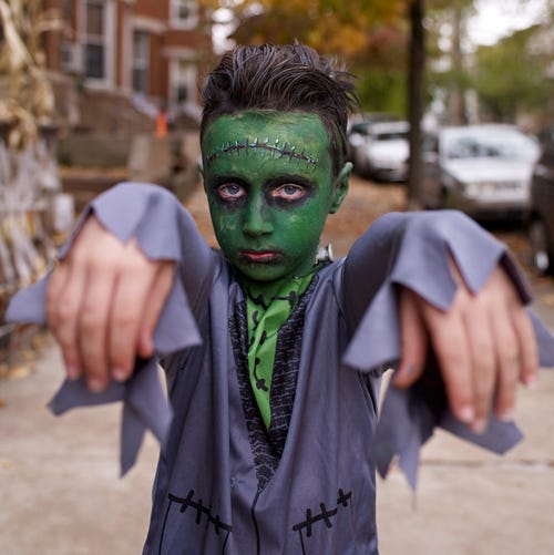 kid in frankenstein halloween costume with green face paint