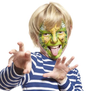 young boy with face painting monster smiling on white background