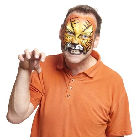 man with face painting tiger growling on white background