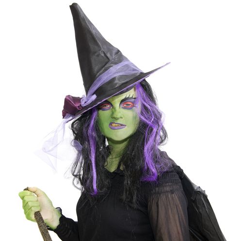 a woman dressed up like witch for halloween with green face paint a black and purple wig and a tall witch hat