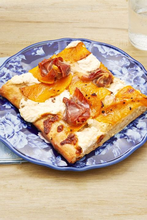 white pizza with butternut squash and prosciutto on blue plate