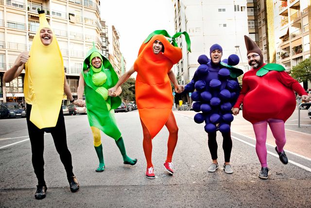 Friends running in fruit and vegetable costumes