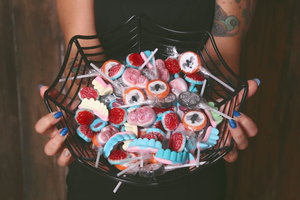 woman holding a container of candy