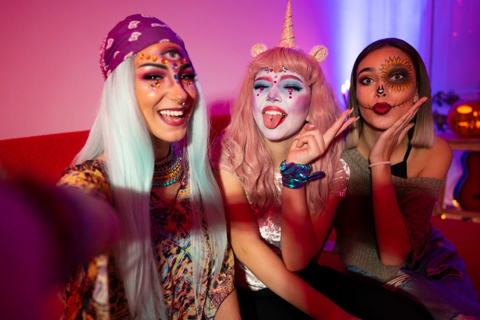 girls taking selfies at halloween party