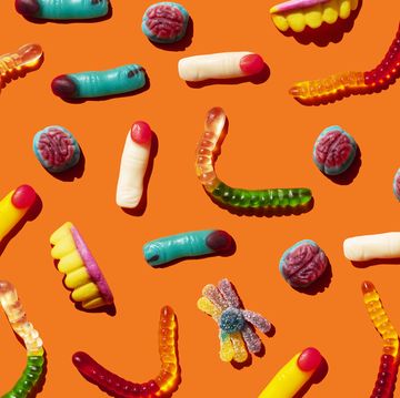 halloween jelly beans, finger shaped, brains, worm and vampire teeth on orange background