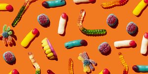 halloween jelly beans, finger shaped, brains, worm and vampire teeth on orange background
