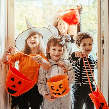 children in halloween costumes trick or treating together