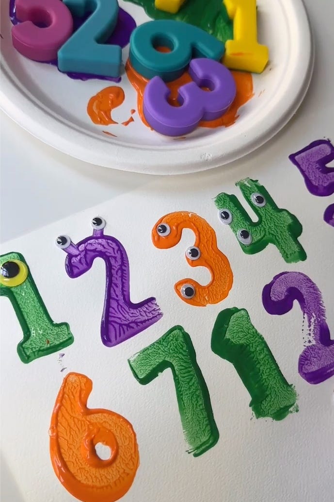 paint stamped block numbers decorated with googly eyes to look like monsters