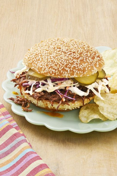 instant pot bbq beef sandwiches with slaw and pickles and chips on the side