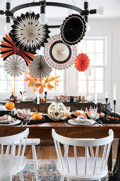 halloween party ideas, vintage inspired tablescape with paper fans, diy treats bags on the table