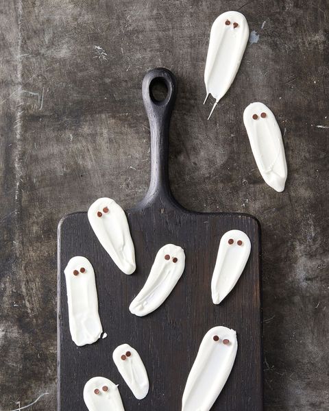 white chocolate ghosts on a black board