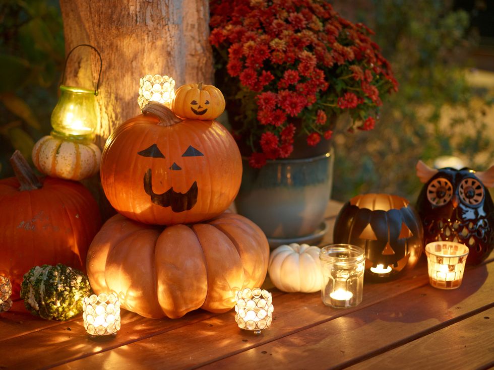 halloween decoration with pumpkins and candles on patio