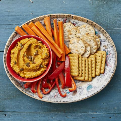 roasted garlic pumpkin hummus with peppers carrots and crackers
