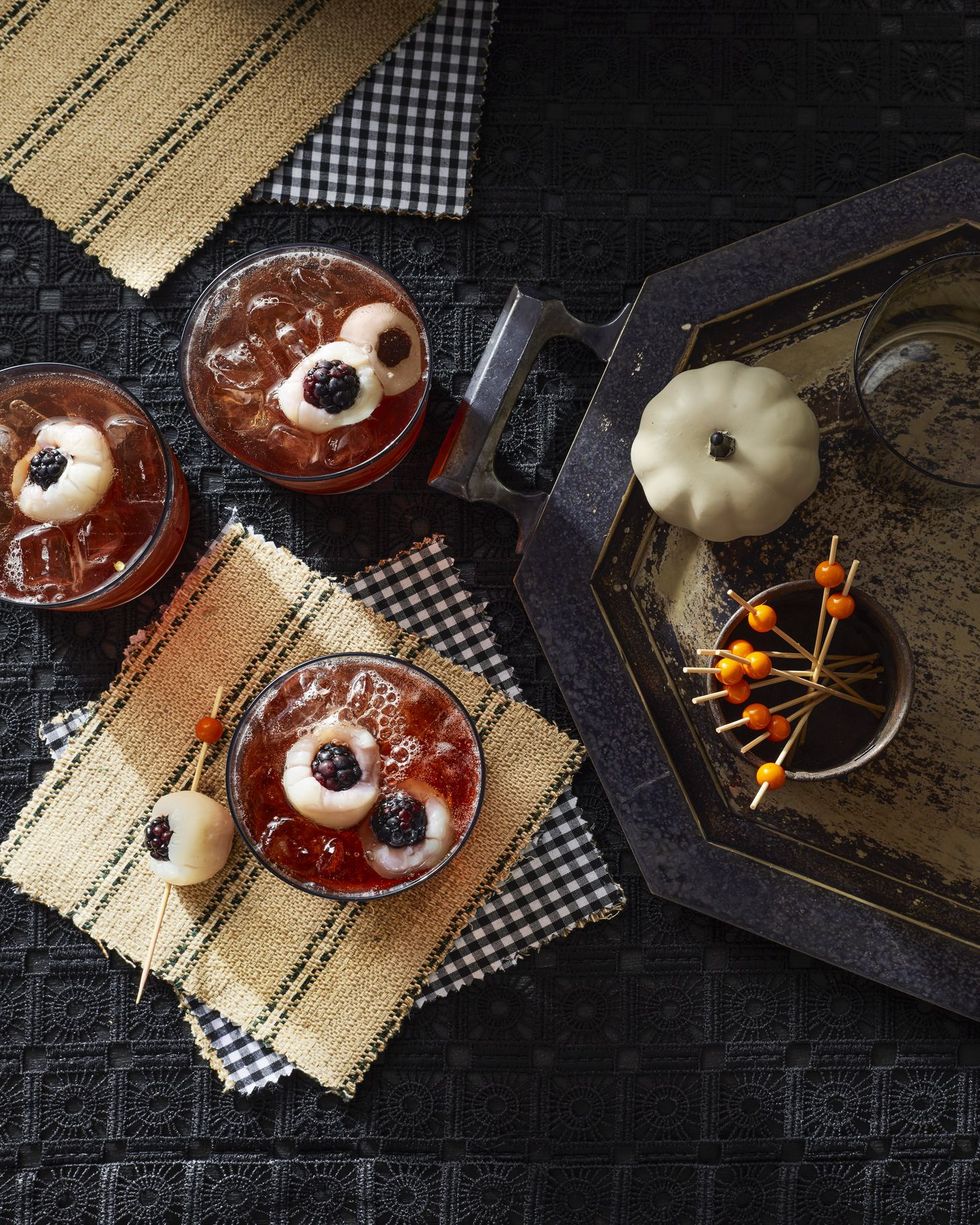 halloween punch tart cherry punch in glasses with lychee nut blackberry eyeballs for garnish