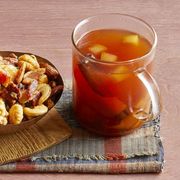 apple cider in glass mug with side of nuts