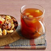 halloween punch recipes apple cider in glass mug with side of nuts