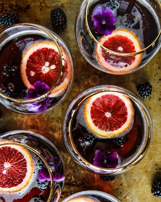 blood orange blackberry rum punch with purple flowers