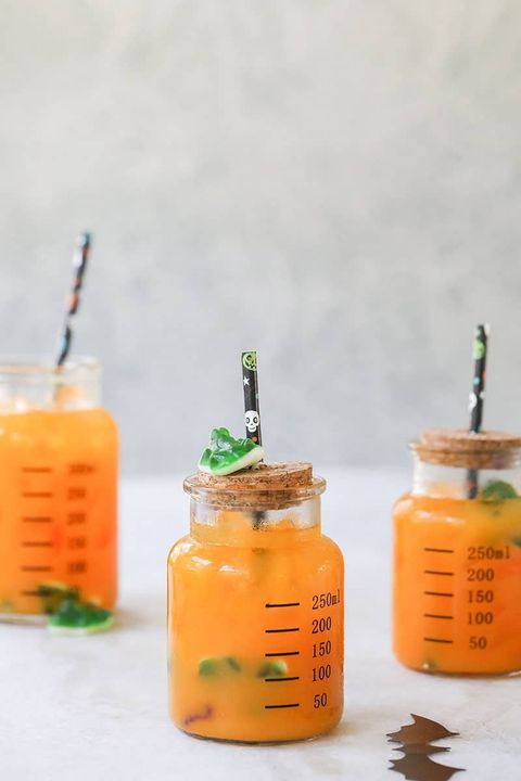 kids halloween punch in beakers with gummy frogs