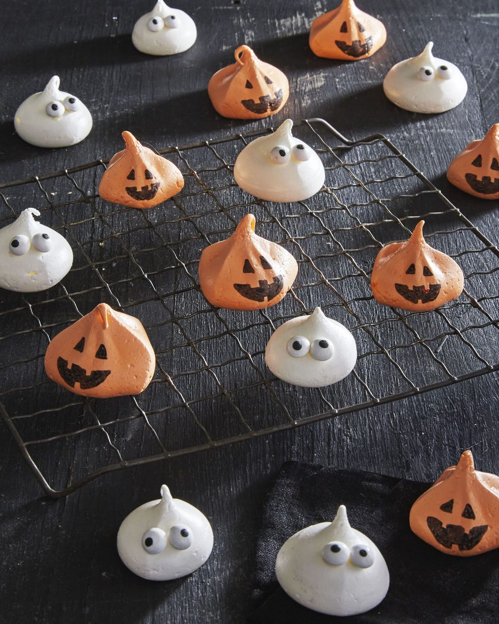 meringue ghost and pumpkin cookies on a wire rack