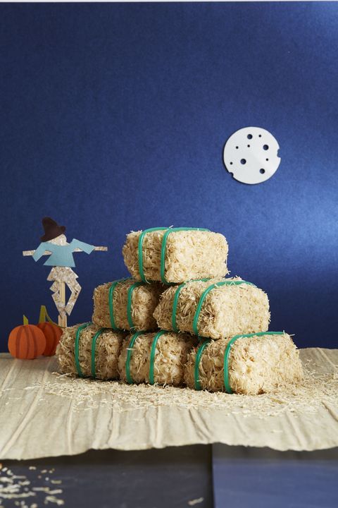 cereal bar hay bales arranged in a stack with a paper scarecrow and paper pumpkins in the background