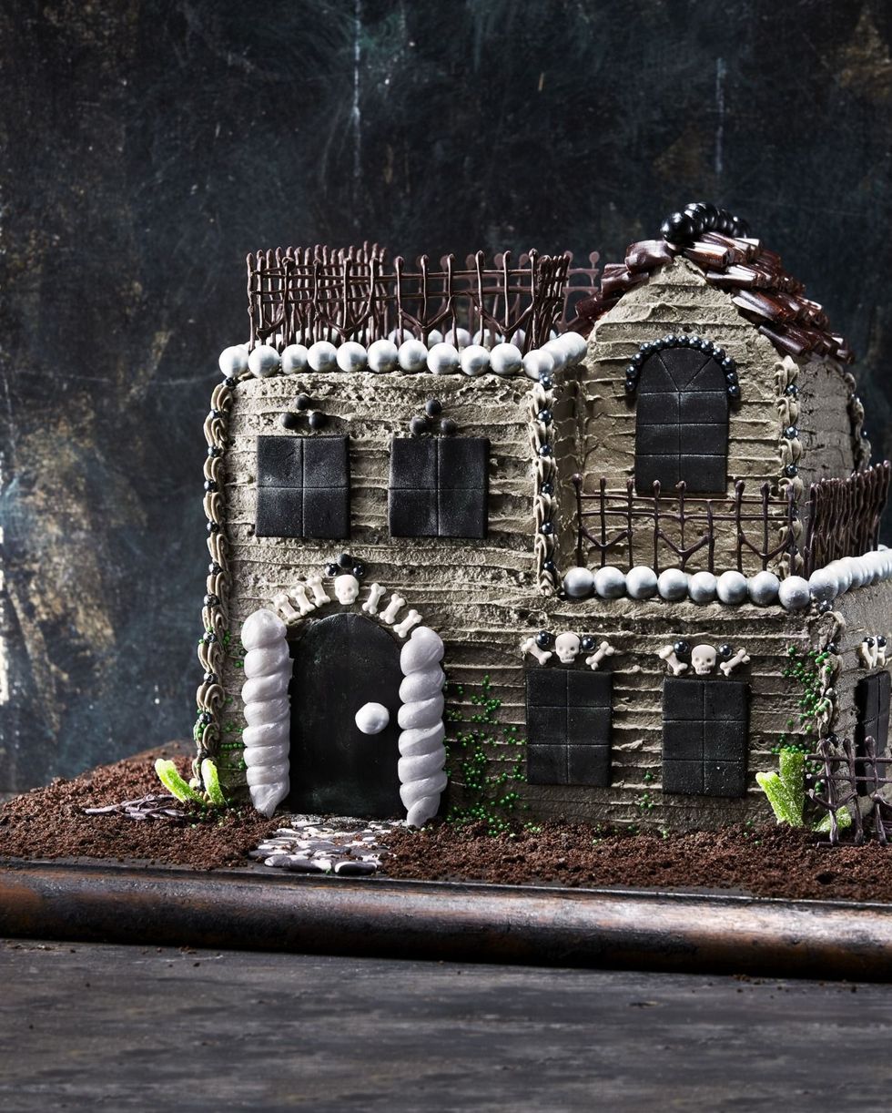 haunted house cake on a wooden serving board