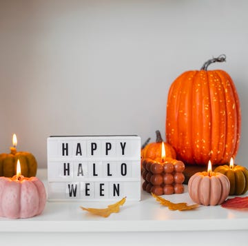 halloween wishes and messages - a lightbox with happy halloween on it surrounded by pumpkins and lit pumpkin candles a lightbox with happy halloween on it surrounded by pumpkins and lit pumpkin candles