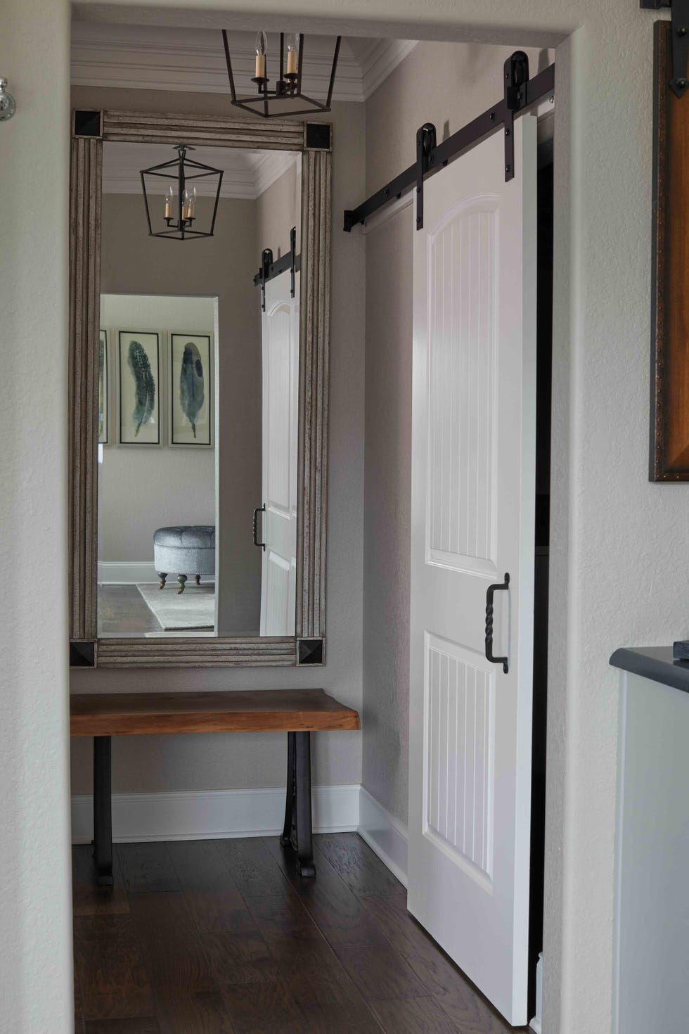 a hallway with mirror and bench