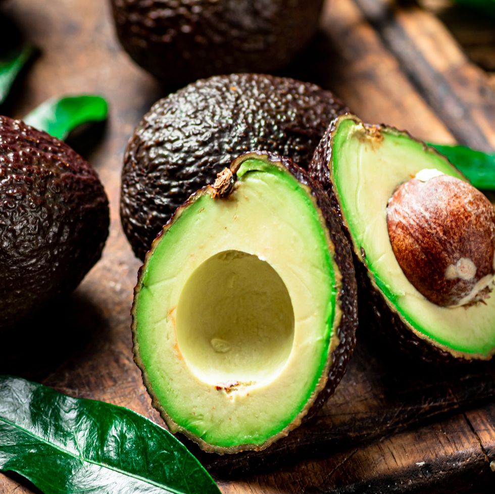 halves of fresh avocado on a cutting board