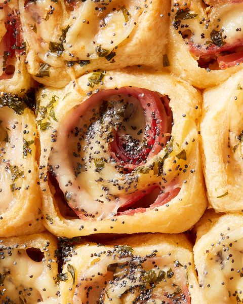 close up of ham and cheese pinwheels topped with poppy seeds