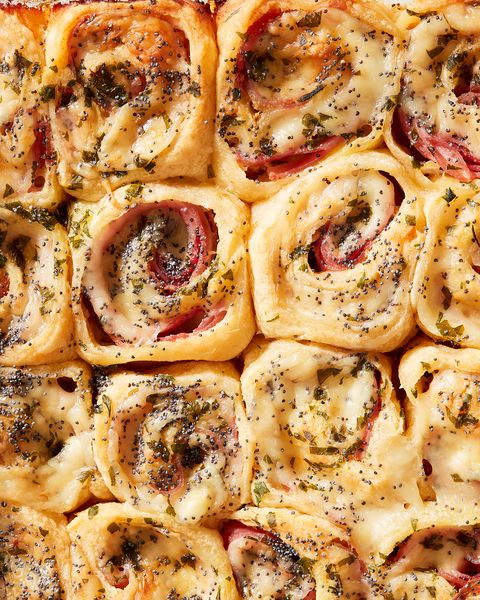 close up of ham and cheese pinwheels garnished with poppy seeds