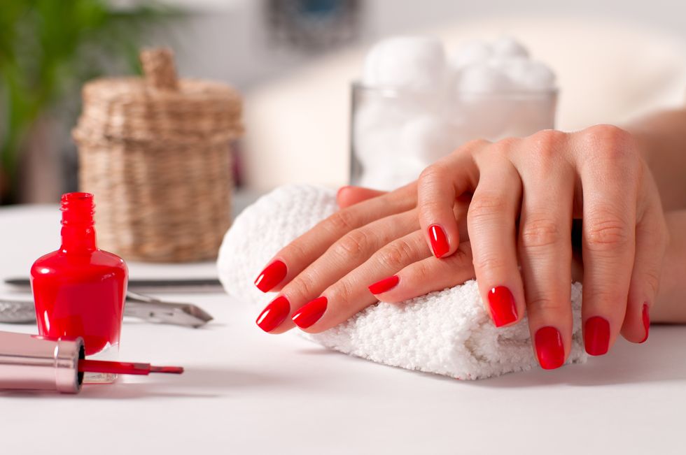 Hand care. Beautiful manicure, woman's hands with red nails