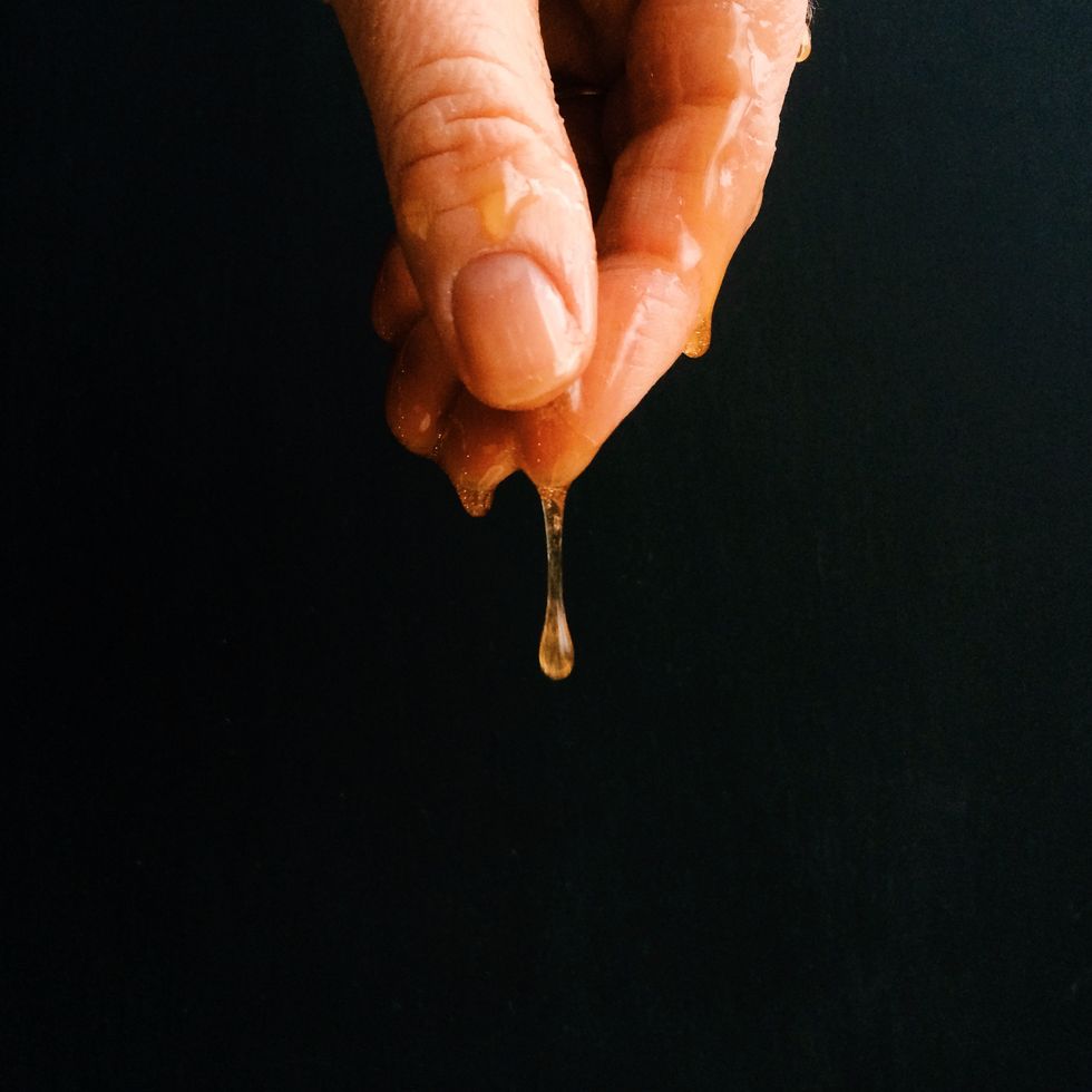 hand dripping with honey