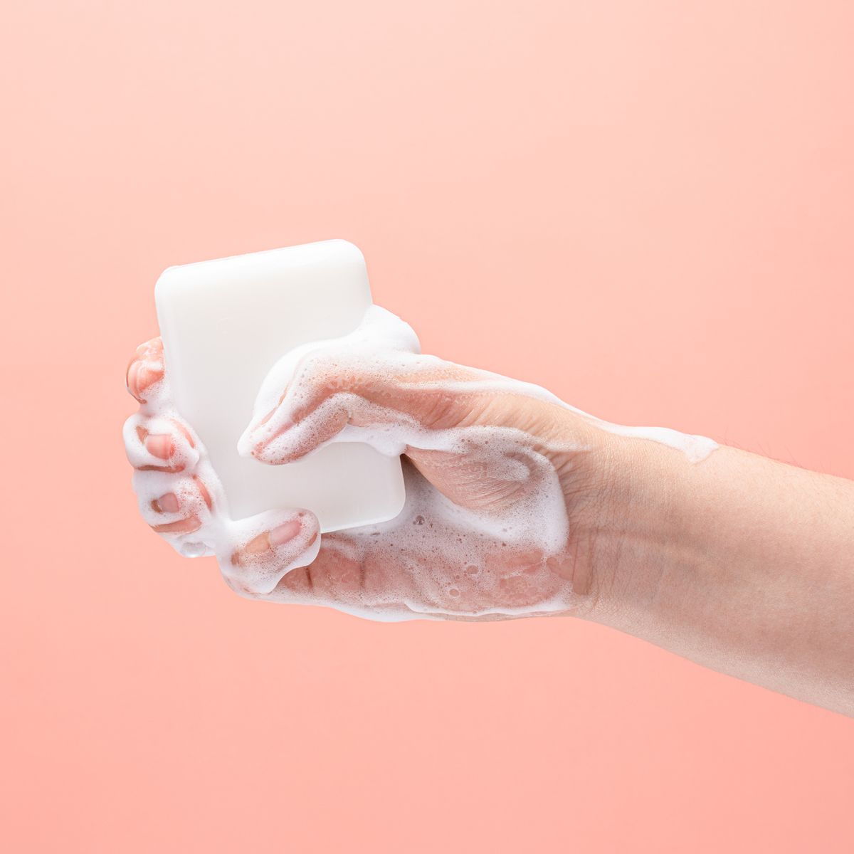 hand gripping a white soap