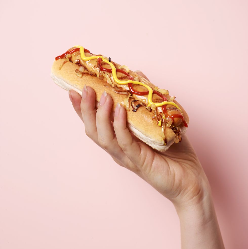 hand holding hotdog