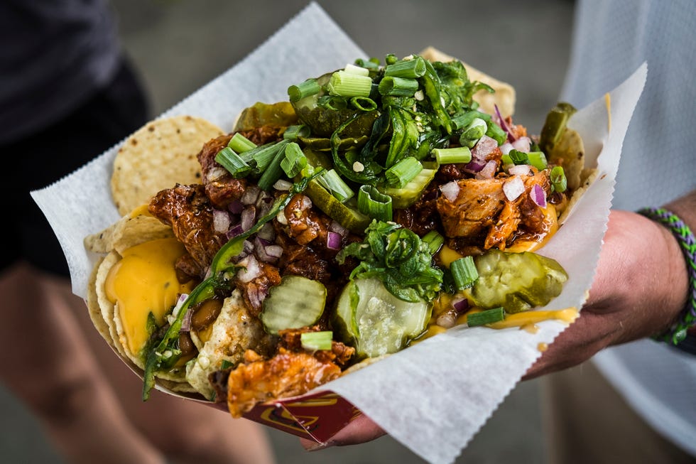 hand holding loaded nachos