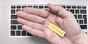 Hand holding note saying Password