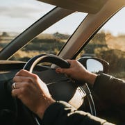 hand holding steering wheel in a car