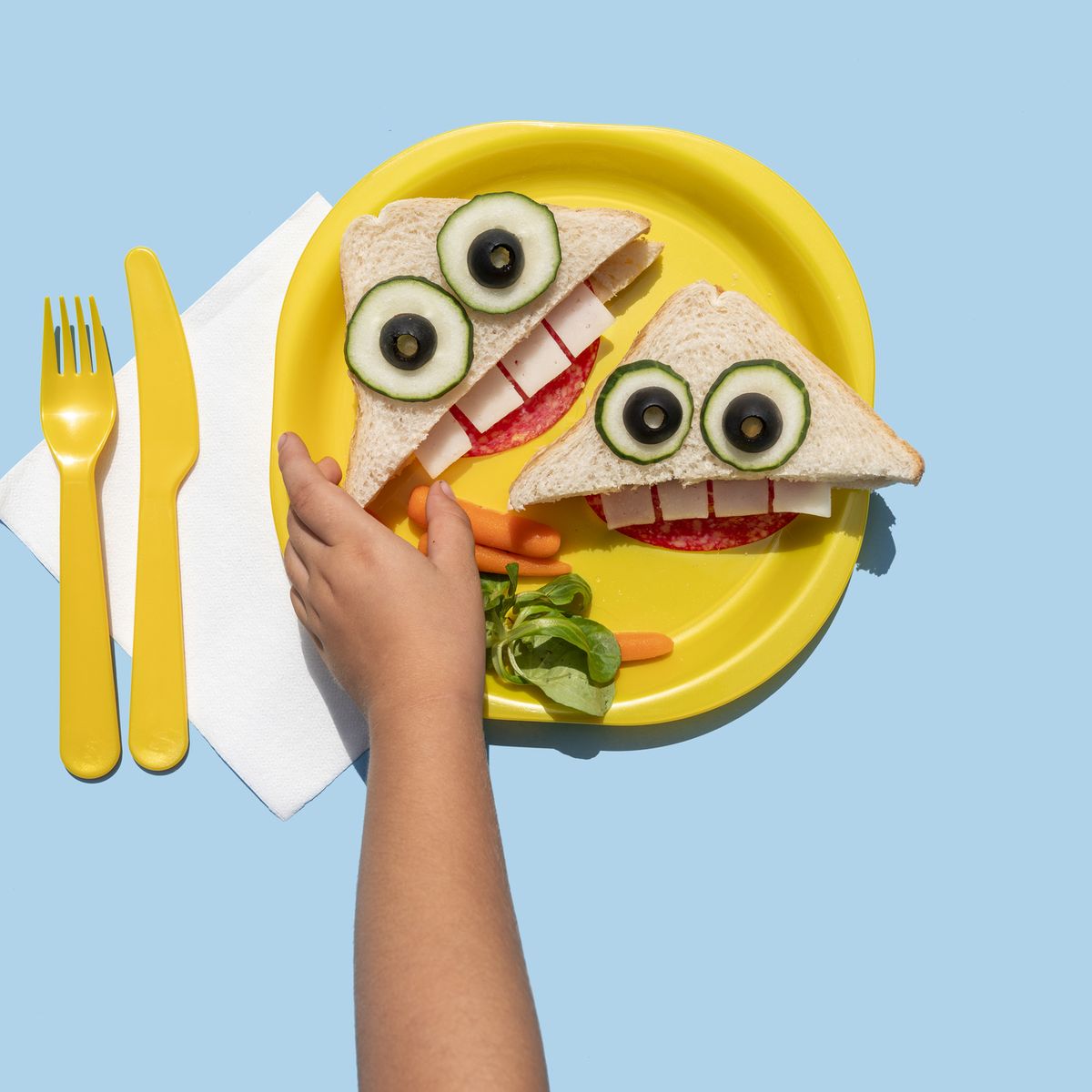 https://hips.hearstapps.com/hmg-prod/images/hand-of-baby-girl-picking-up-funny-looking-sandwich-royalty-free-image-1654027736.jpg?crop=0.66698xw:1xh;center,top&resize=1200:*