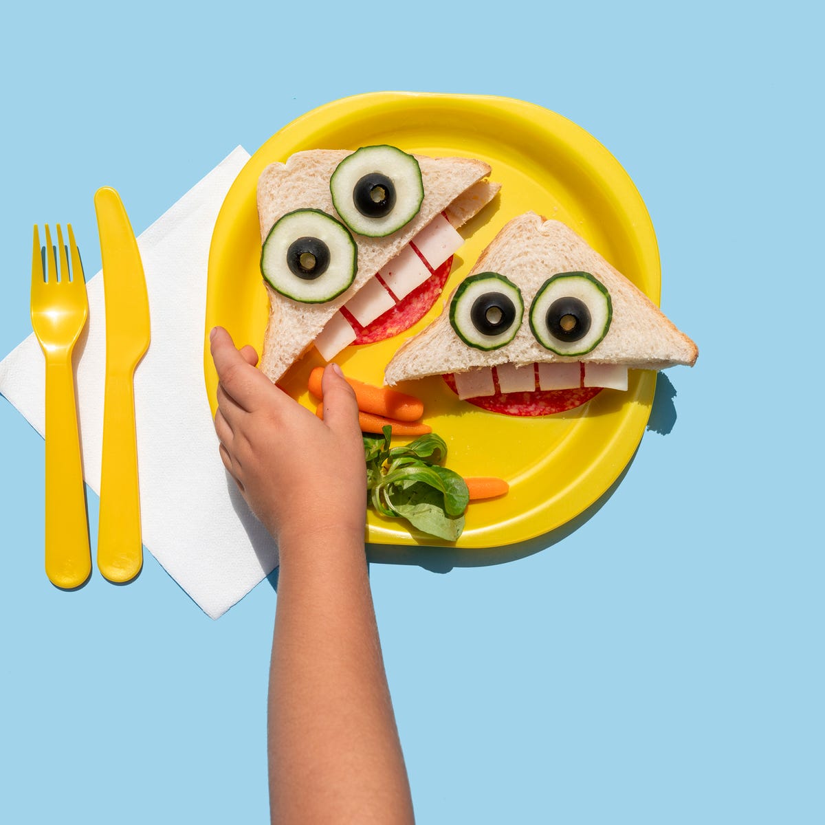 https://hips.hearstapps.com/hmg-prod/images/hand-of-baby-girl-picking-up-funny-looking-sandwich-royalty-free-image-1654027736.jpg?crop=0.66698xw:1xh;center,top&resize=1200:*